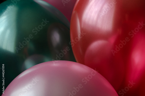 Shiny Balloons close-up. Red, pink and green. Holiday attribute.