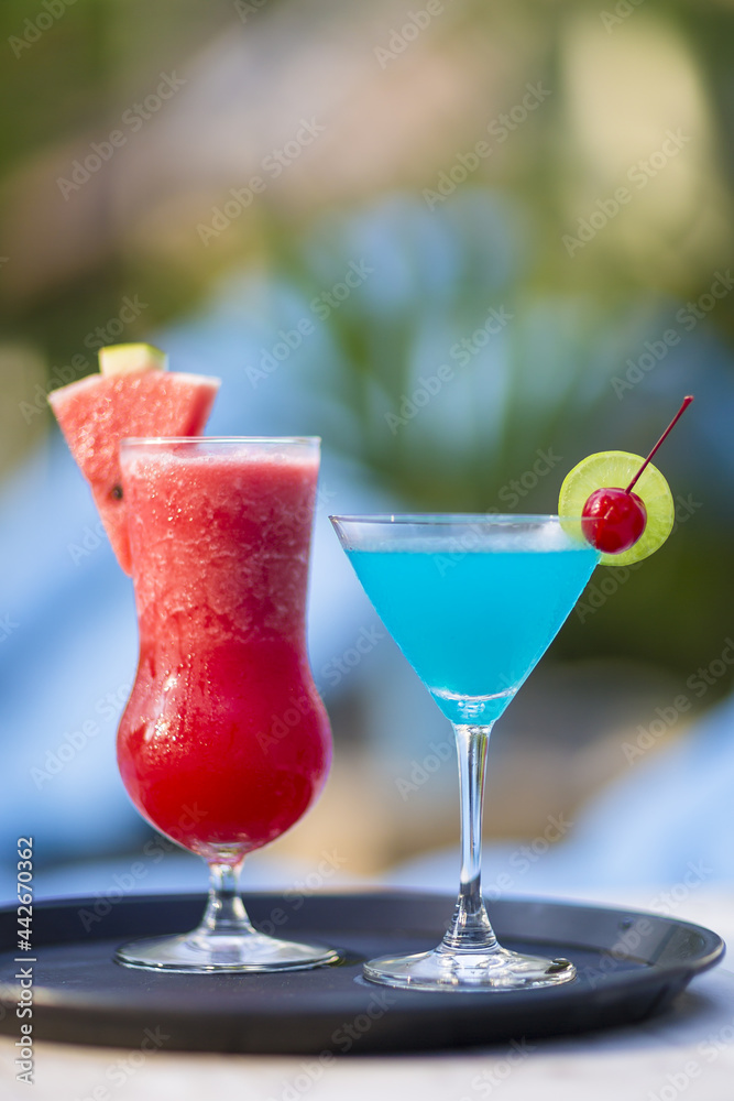 Red and Blue Cocktails in Different Glasses with Blurred Background
