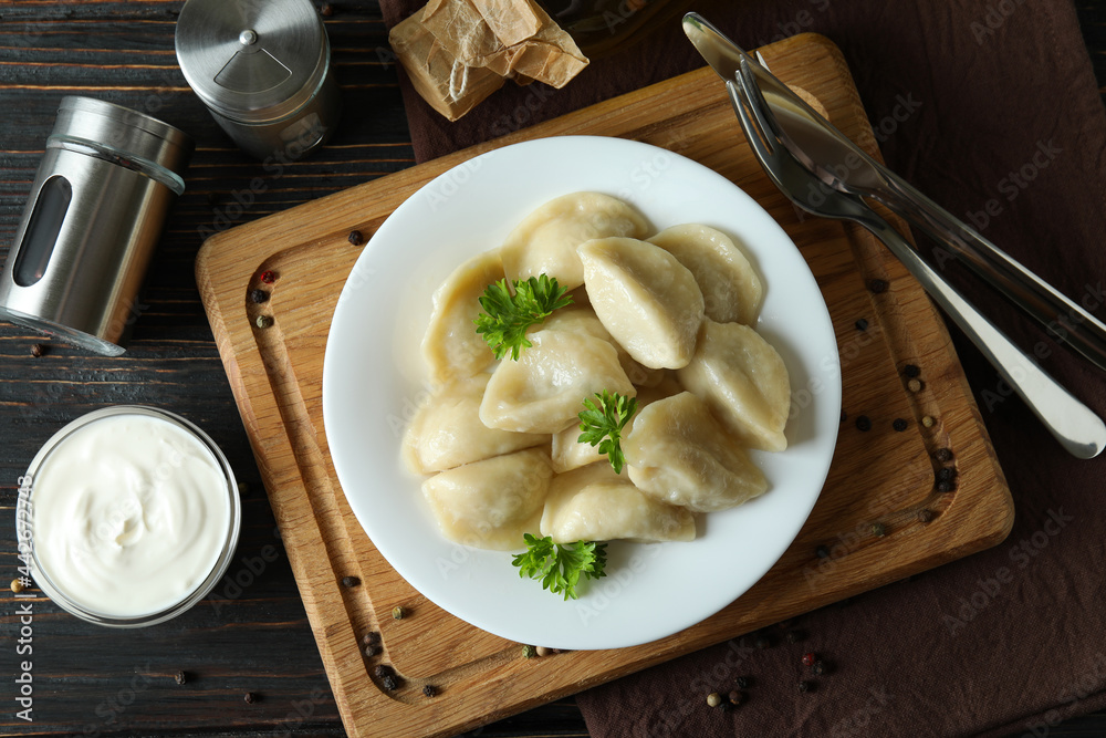 Concept of tasty food with vareniki or pierogi on wooden table Concept of tasty food with vareniki or pierogi on wooden table