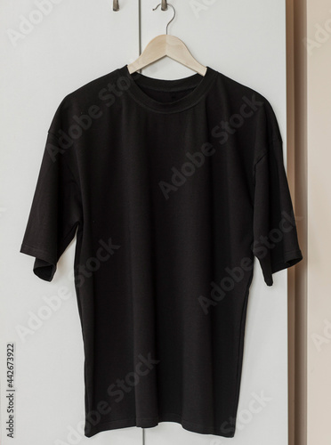 Black t-shirt on hanger ready for your own graphics