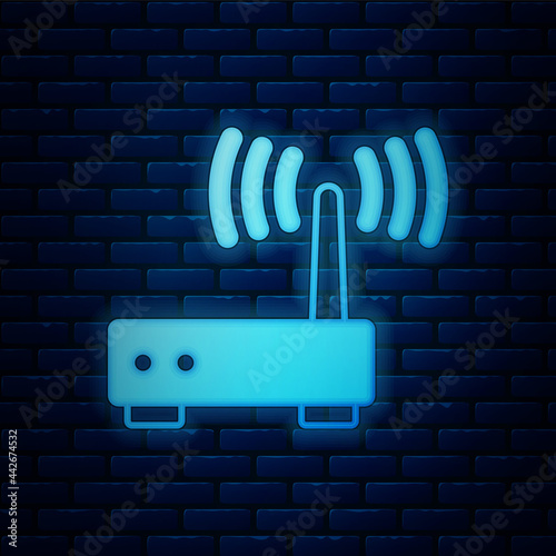 Glowing neon Router and wi-fi signal icon isolated on brick wall background. Wireless ethernet modem router. Computer technology internet. Vector
