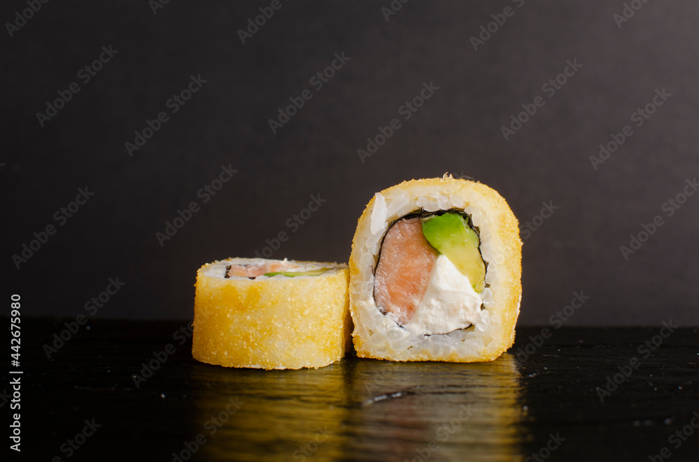Sushi. fried maki with salmon, avocado and cheese Sushi. fried maki with salmon, avocado and cheese