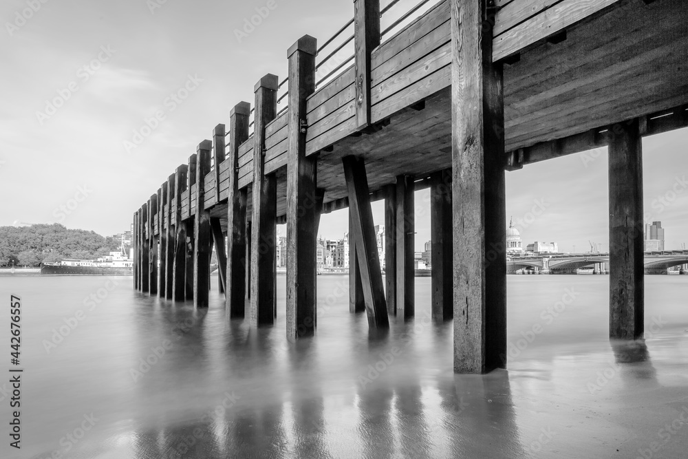 Wooden pier on the river Thames in London black and white long exposure beach monochrome wooden jetty smooth water 