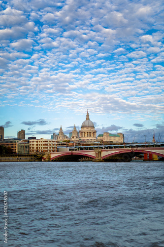 Canvas Print London skyline of St Paul's cathedral and the river Thames with blue sky and tex