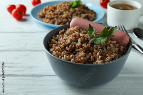 Concept of tasty eating with buckwheat on wooden table