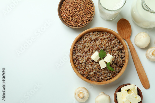 Concept of cooking buckwheat on white background