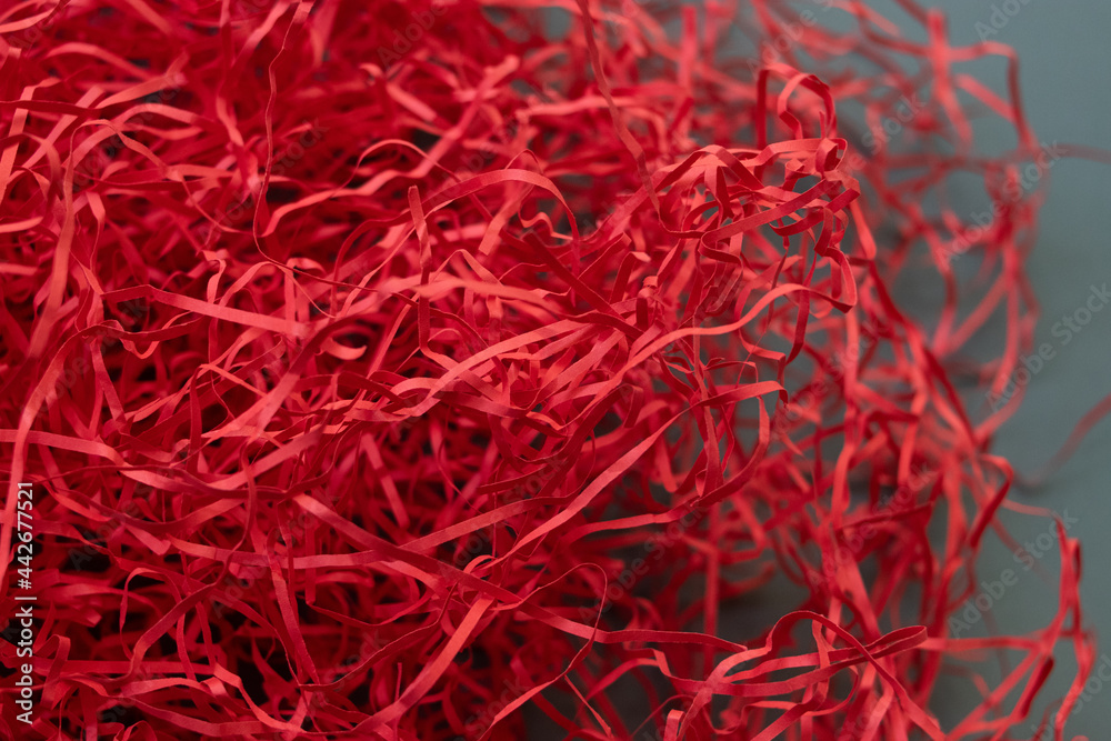 Naklejka premium red shreded paper on grey background