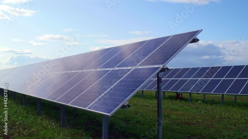 Brilliant solar panels on the field on which the green grass grows. A private company producing solar panels and energy storage systems. High quality. 4k footage.