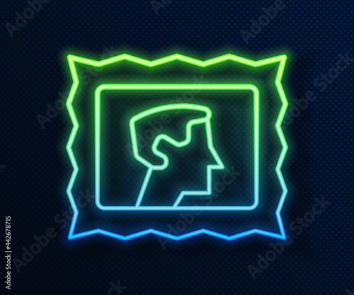 Glowing neon line Postal stamp icon isolated on blue background. Vector