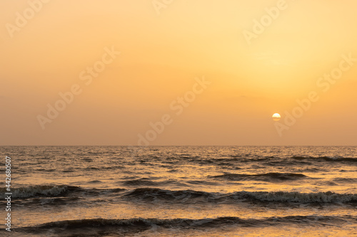 A view of sun setting in the horizon and waves in the ocean © Sandeep