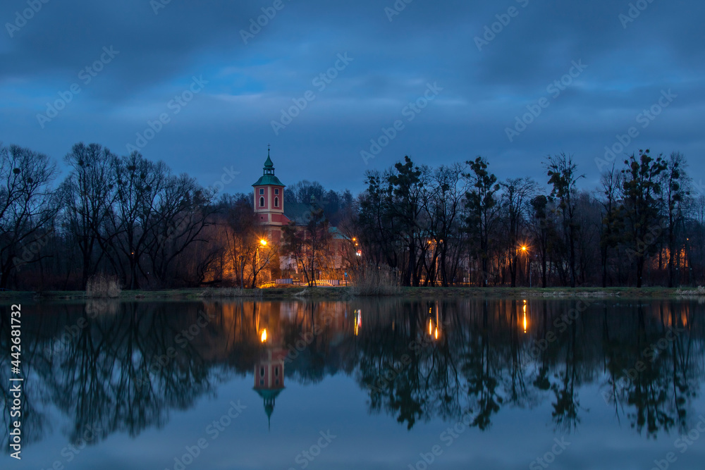 Reflection of the church in the pond after sunset
