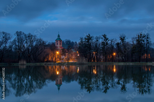 Reflection of the church in the pond after sunset