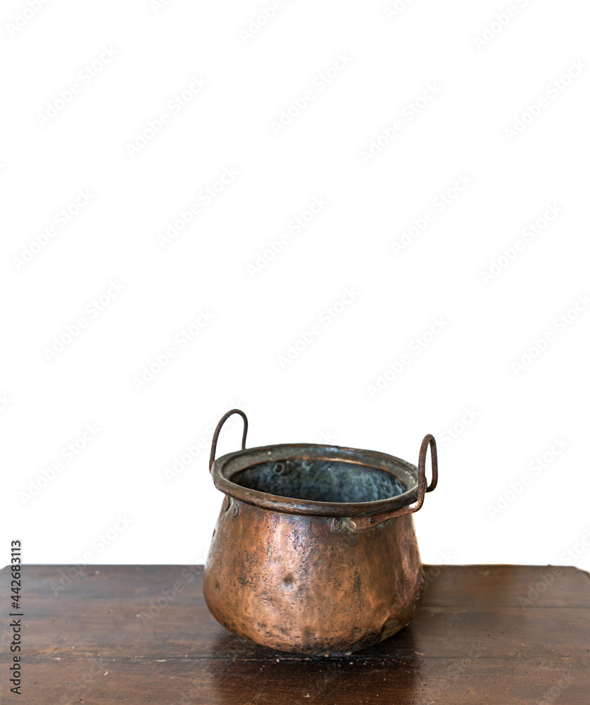 Antique copper pot over the table and white background Antique copper pot over the table and white background