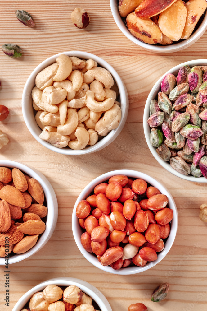 Cashews, peanuts and many other nuts, shot from above on a rustic wooden table Cashews, peanuts and many other nuts, shot from above on a rustic wooden table