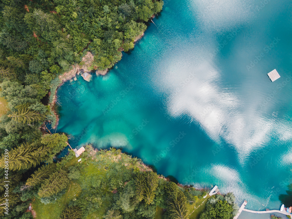 Drone view blue lake with forest in Switzerland mountains