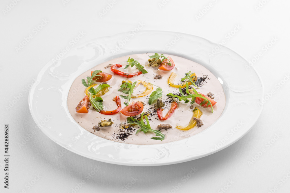 Vitello tonnato traditional italian dish on white plate isolated on white background Vitello tonnato traditional italian dish on white plate isolated on white background