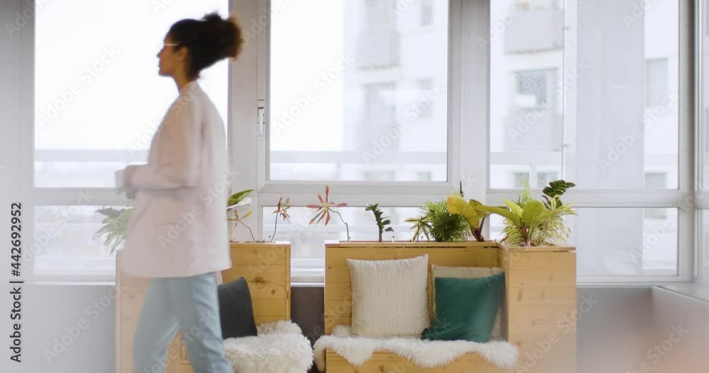Businesswoman sitting on sustainable wood sofa for coffee Businesswoman sitting on sustainable wood sofa for coffee