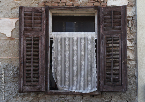 old window with embroidered curtain, Pula, Croatia