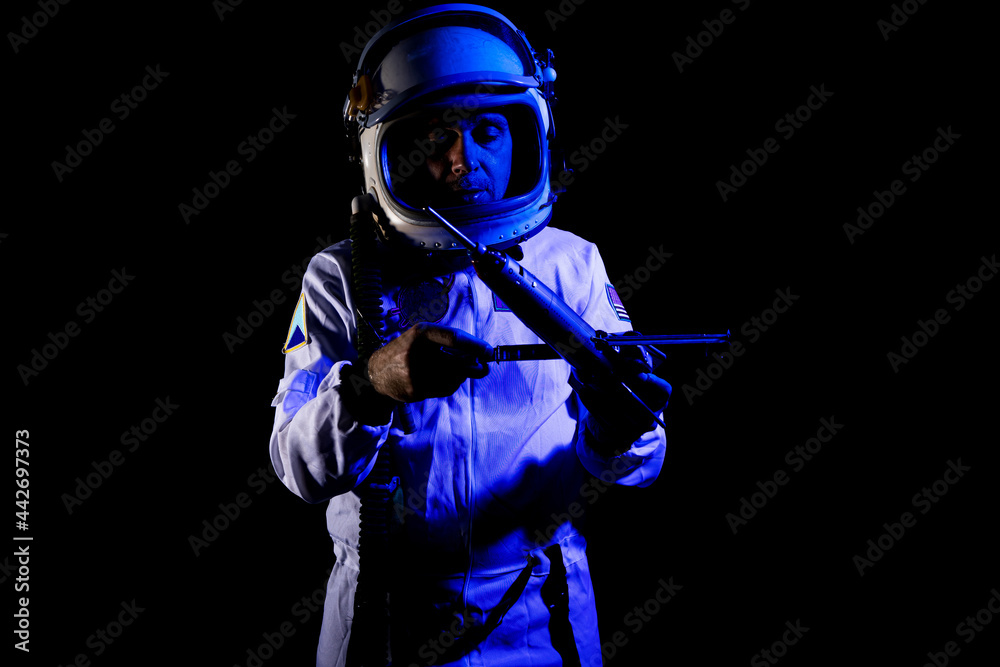 Astronaut in space suit standing in blue neon light