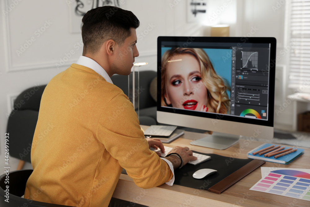 Professional retoucher working on computer in office Professional retoucher working on computer in office