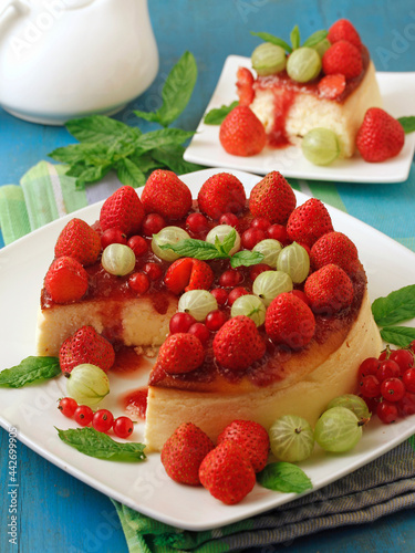 Cheesecake tart with strawberries  red currants and gooseberries.