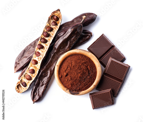 Carob pod with carob powder and chocolate on white backgrounds.