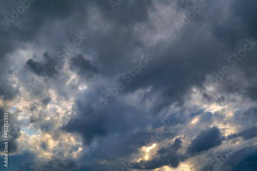 Summer evening sky in the picturesque clouds, lit by the rays of the setting sun.