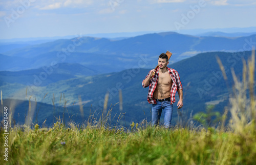 Guy hiker enjoy pure nature. Musician hiker find inspiration in mountains. Peaceful hiker. Carefree wanderer. Vast expanses. Conquer the peaks. Man hiker with guitar walking on top of mountain