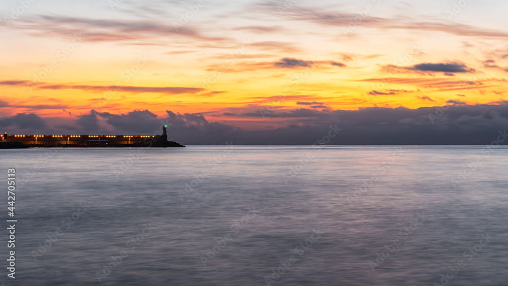 Sunrise from the port of Gandia, with beautiful clouds on the horizon.