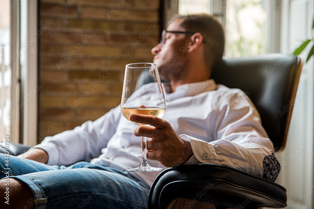 Handsome man relaxing at home with glass of wine Handsome man relaxing at home with glass of wine