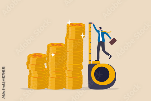 Investment measurement or benchmark, ROI, return on investment, wealth monitoring with financial goal or target concept, businessman investor using measuring tape to measure money coins stack height.