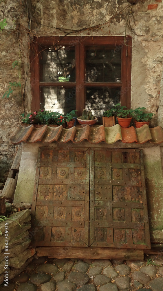 window with flowers and traditional wooden cellar, Tallinn, Estonia window with flowers and traditional wooden cellar, Tallinn, Estonia