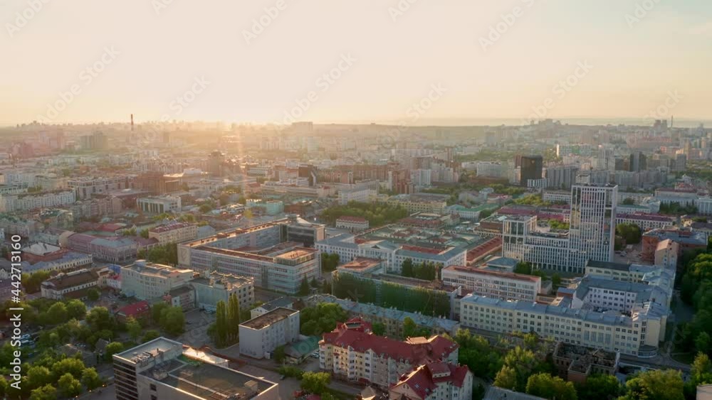Sunset on the horizon. View of the multi-colored roofs of high-rise buildings. Dense urban development, business center. Public places, urban environment. High quality. 4k footage. Sunset on the horizon. View of the multi-colored roofs of high-rise buildings. Dense urban development, business center. Public places, urban environment. High quality. 4k footage.