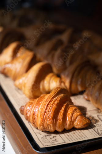 Freshly baked croissants, golden brown on paper, ready to serve in the morning. © stpadcharin
