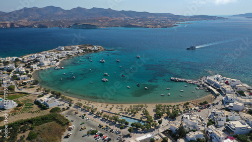 Aerial drone photo of picturesque fishing village of Polonia or Pollonia with traditional fishing boats anchored next to island of Kimolos, Milos island, Cyclades, Greece