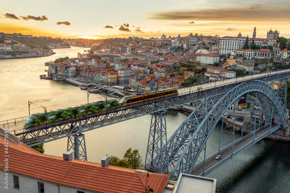 Skyline of the historic city of Porto with bridge by sunset, Portugal