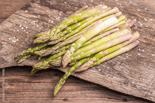 Ripe asparagus ready for cooking on vintage wooden stands