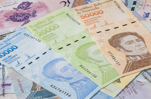 Close up to the currency of the south American country Venezuela. High inflation and weak economy increases the denomination of the banknotes. Bolivares or Bolivar money of the republic Venezuela  photo