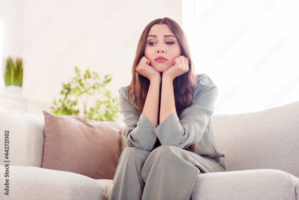 Photo of young attractive girl hands touch cheeks unhappy sad upset boring depressed sit couch home alone Photo of young attractive girl hands touch cheeks unhappy sad upset boring depressed sit couch home alone