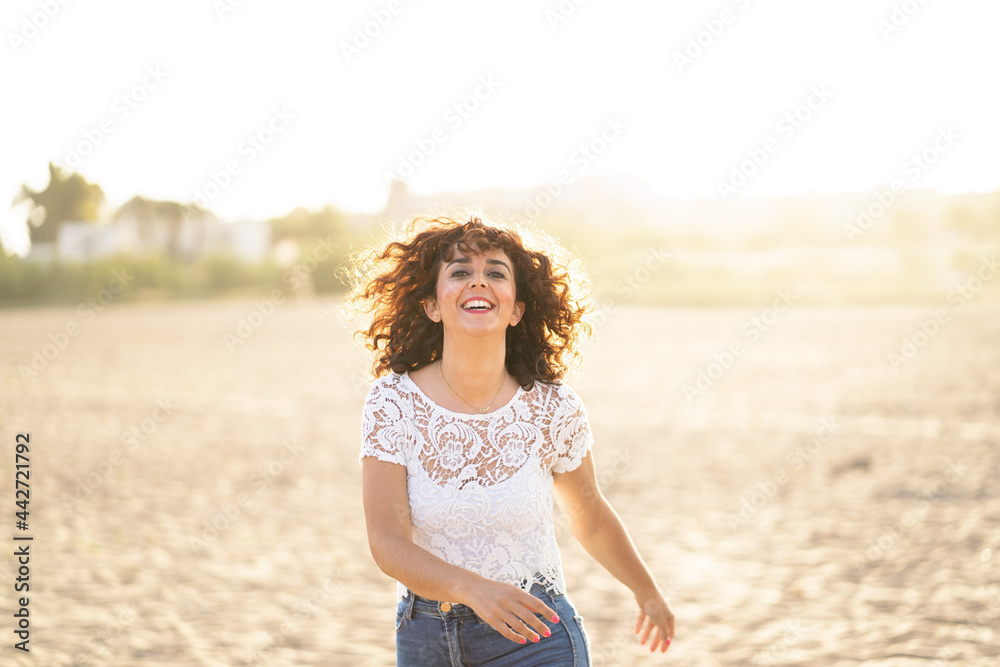 Horizontal portrait of woman running in the beach at sunset. Happiness summer lifestyle concept. Horizontal portrait of woman running in the beach at sunset. Happiness summer lifestyle concept.