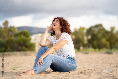 Horizontal view of caucasian woman laughing on holidays in the beach. Travel and tourism concept.