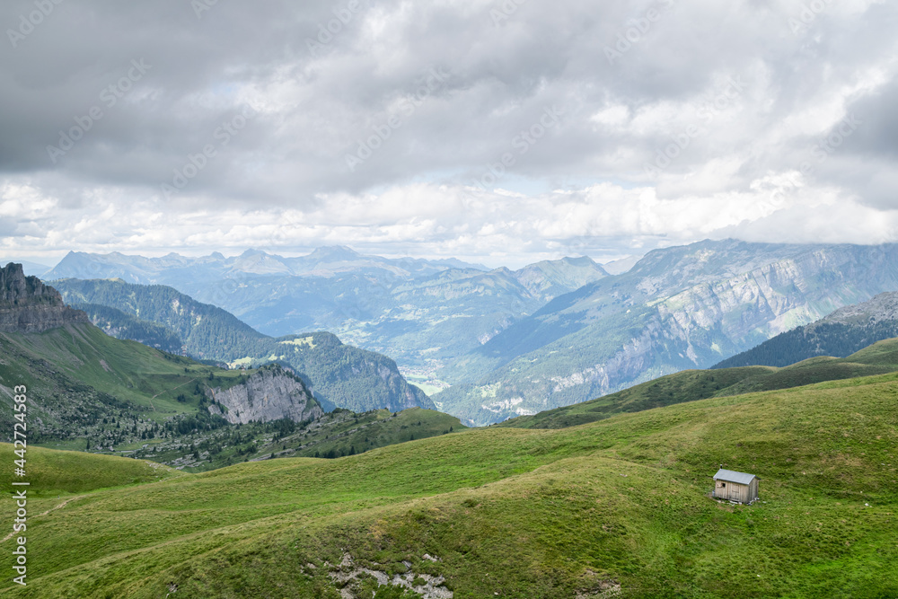 Hiking trail in the french alps mountains landscape with a mountain hut Hiking trail in the french alps mountains landscape with a mountain hut