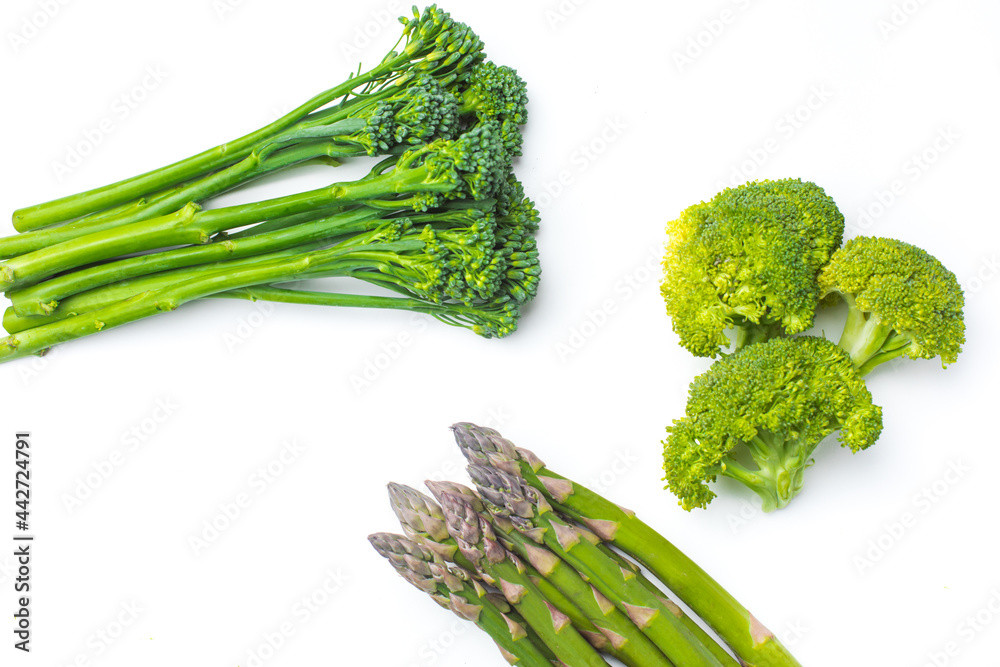 Raw broccolini at the row on white background Raw broccolini at the row on white background