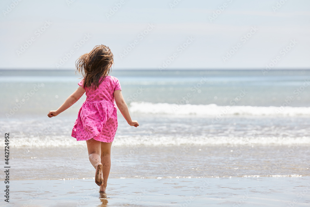 Caucasian girl running to the sea with great copy space for advertising