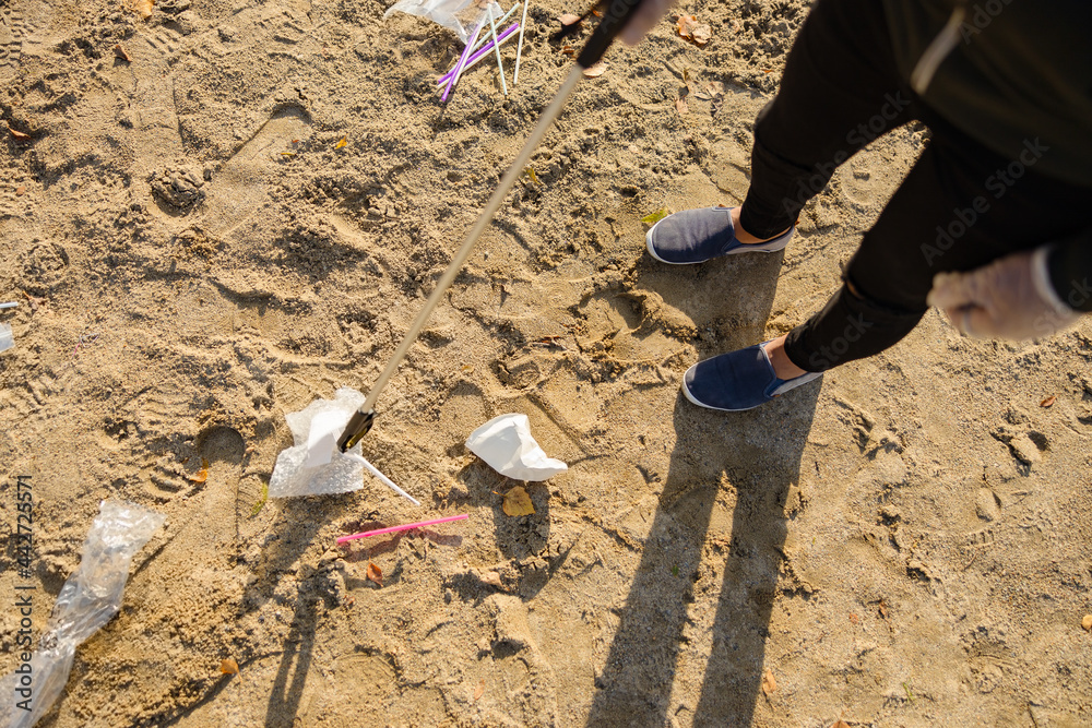 Top view of volunteer protecting environmental and picking up garbage at beach Top view of volunteer protecting environmental and picking up garbage at beach
