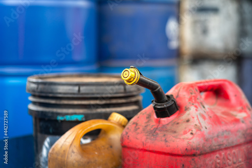 A gasoline or diesel fuel canister which is placed at factory chemical storage area. Industrial object photo. Close-up and selective focus at the containment tube sealing cap. photo