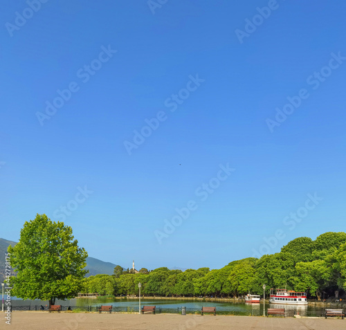 ioannina city in the summer trees by the lake pamvotis greece photo