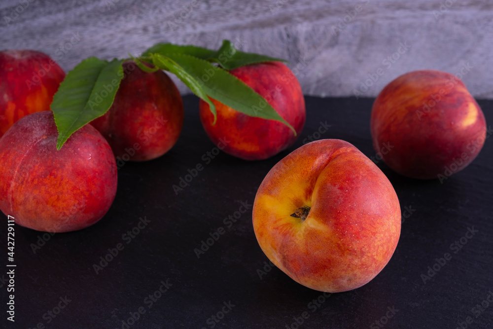 scattered ripe peaches on black background scattered ripe peaches on black background