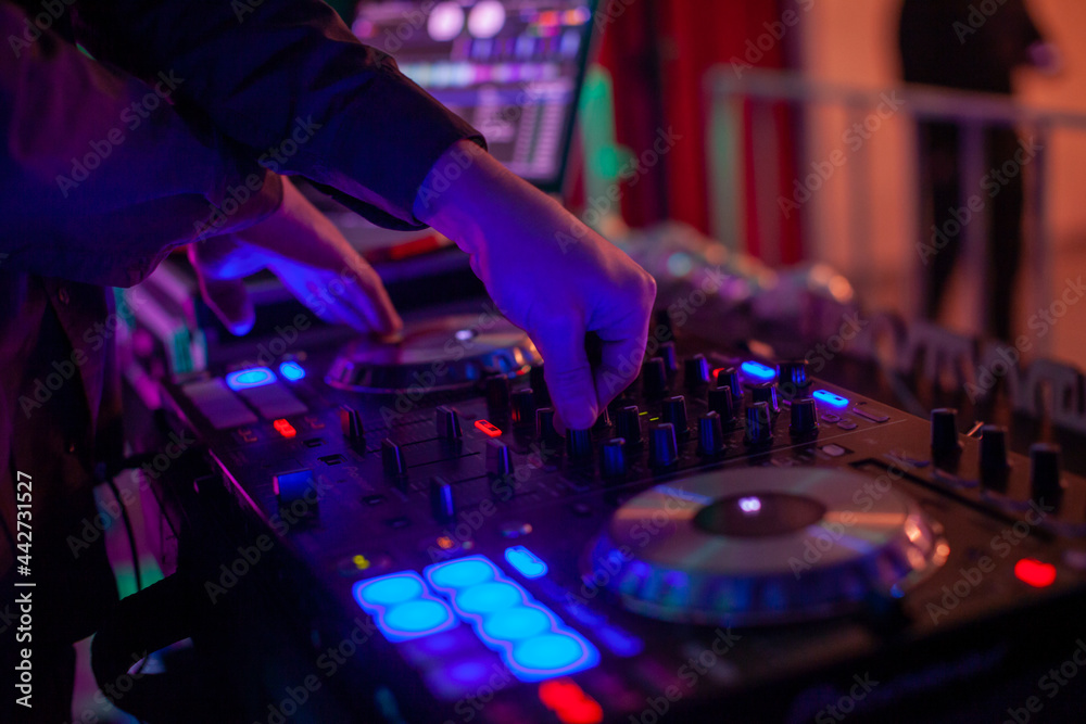 Obraz premium Dj mixing music in night club, close up