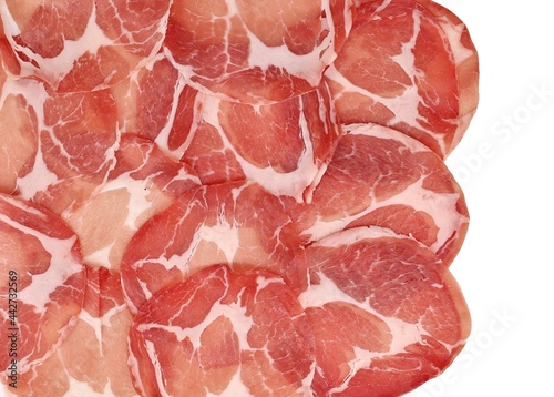 Fotografie Slices of Coppa or Capocollo, traditional Italian and french pork cold cut  made from the  dry cured muscle of the neck,  on white background